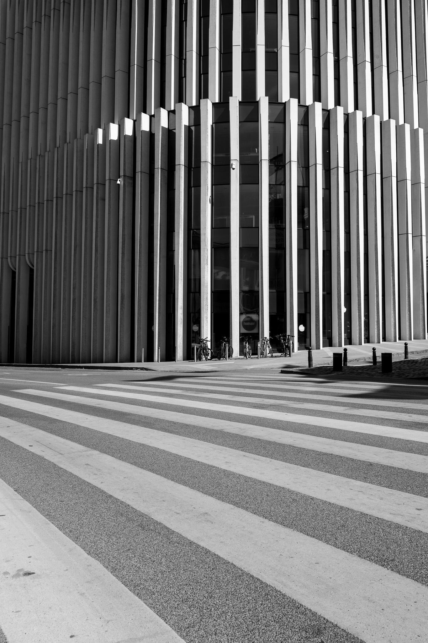 Crosswalk lines echoing the facade of a modern building